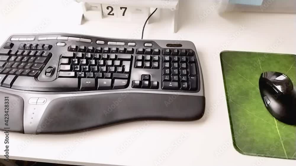 Ergonomic home office equipment with ergonomic keyboard and ergonomic mouse for freelance work and healthy workplace with a white notebook and a clean desktop for efficient work from home in security Ergonomic home office equipment with ergonomic keyboard and ergonomic mouse for freelance work and healthy workplace with a white notebook and a clean desktop for efficient work from home in security
