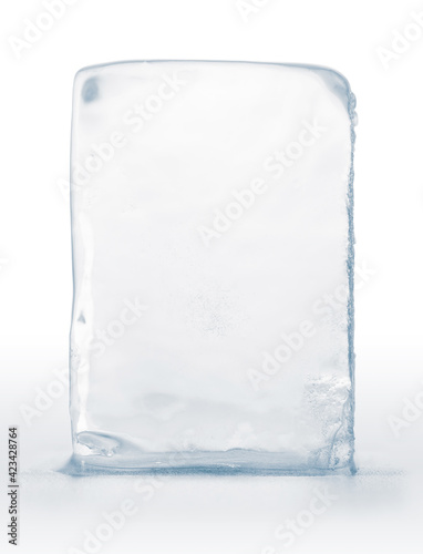 Crystal clear, pure ice block, on white surface with reflection. Big piece of ice.