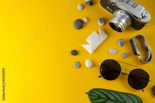 Summer holiday accessories on a yellow background