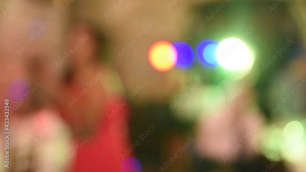 Defocused silhouettes dancing at a party with colored lights Abstract silhouettes dancing Defocused silhouettes dancing at a party with colored lights Abstract silhouettes dancing