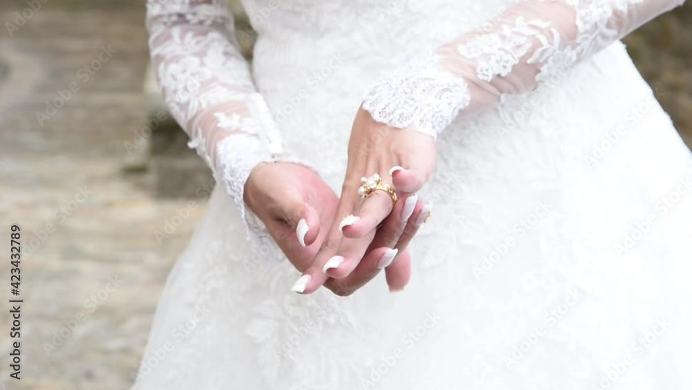 Royal bride showing off her wedding ring. A bride's hands touching her wedding ring. Royal bride showing off her wedding ring. A bride's hands touching her wedding ring.