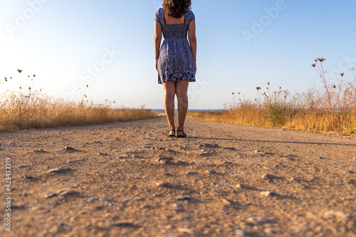 Mediterranean girl with dress on a road
