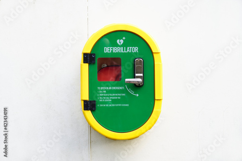 Photos Defibrillator AED on wall in public space for emergency heart resuscitation