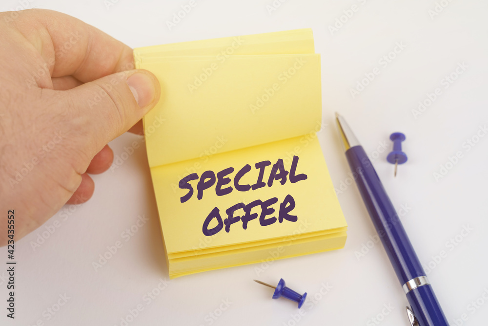 The man is leafing through the stickers, the sheet says - SPECIAL OFFER