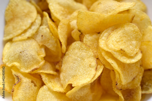 Yellow beautiful delicious chips close up in a restaurant