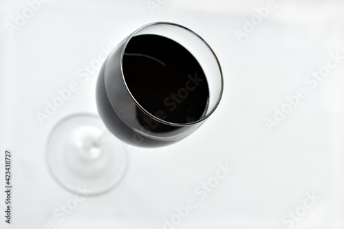 Large glass of red wine on a white background