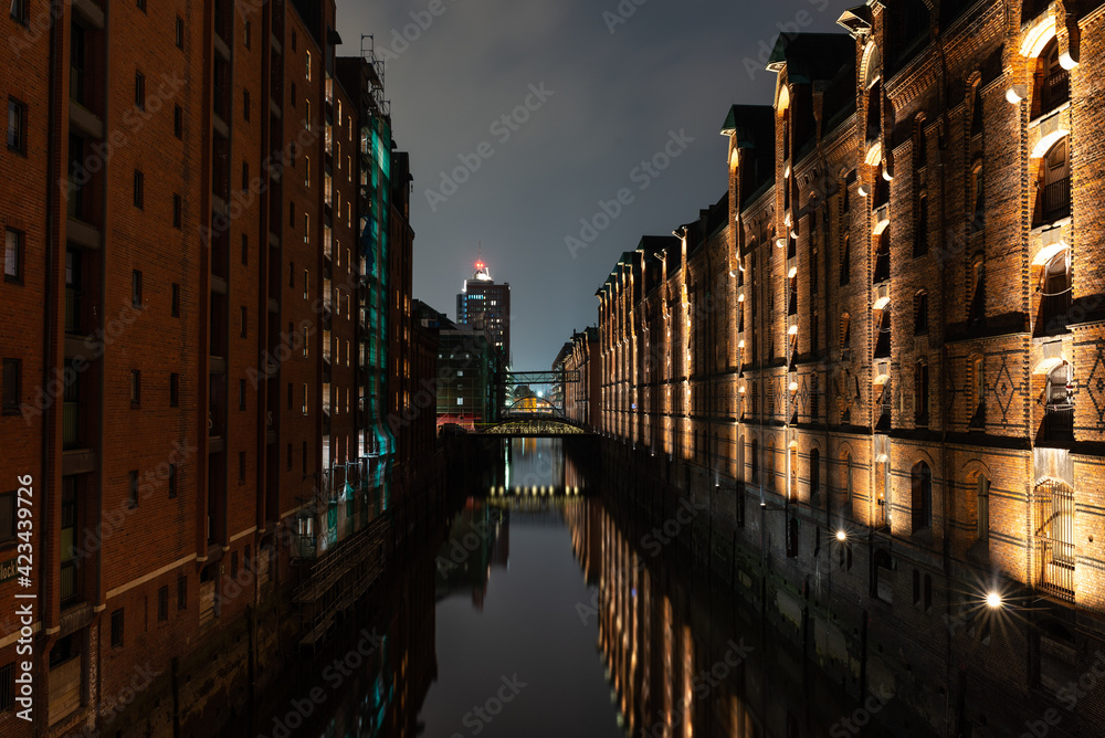 historic Hamburg Speicherstadt at night with relfections in the water