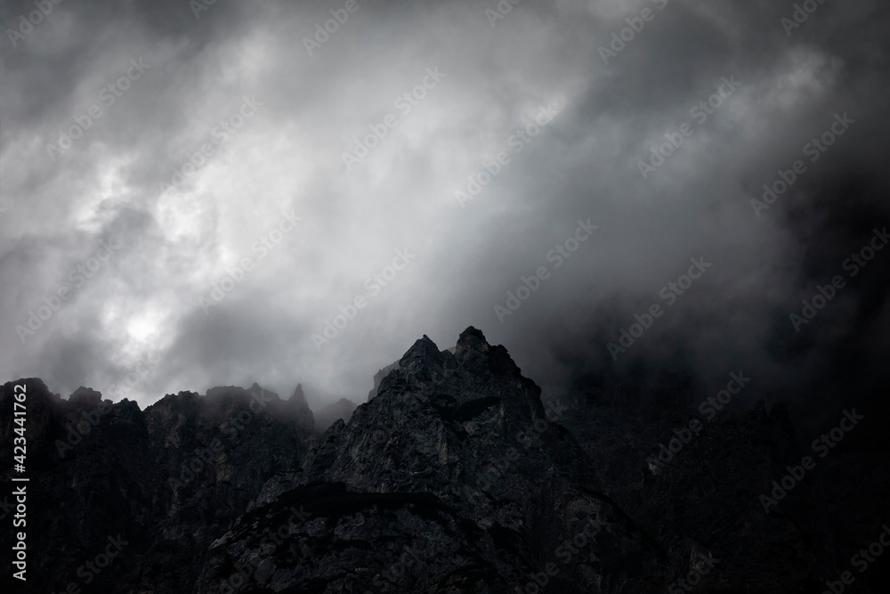 dark couds around mountain peak dark couds around mountain peak