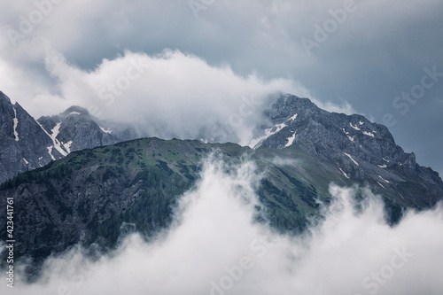 fog and clouds around mountain top © Olha Rohulya