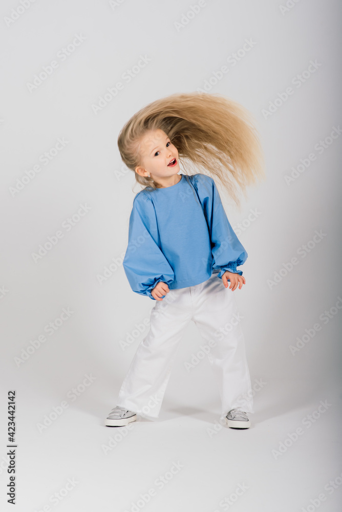 Portrait smiling child girl with flying blond hair Portrait smiling child girl with flying blond hair