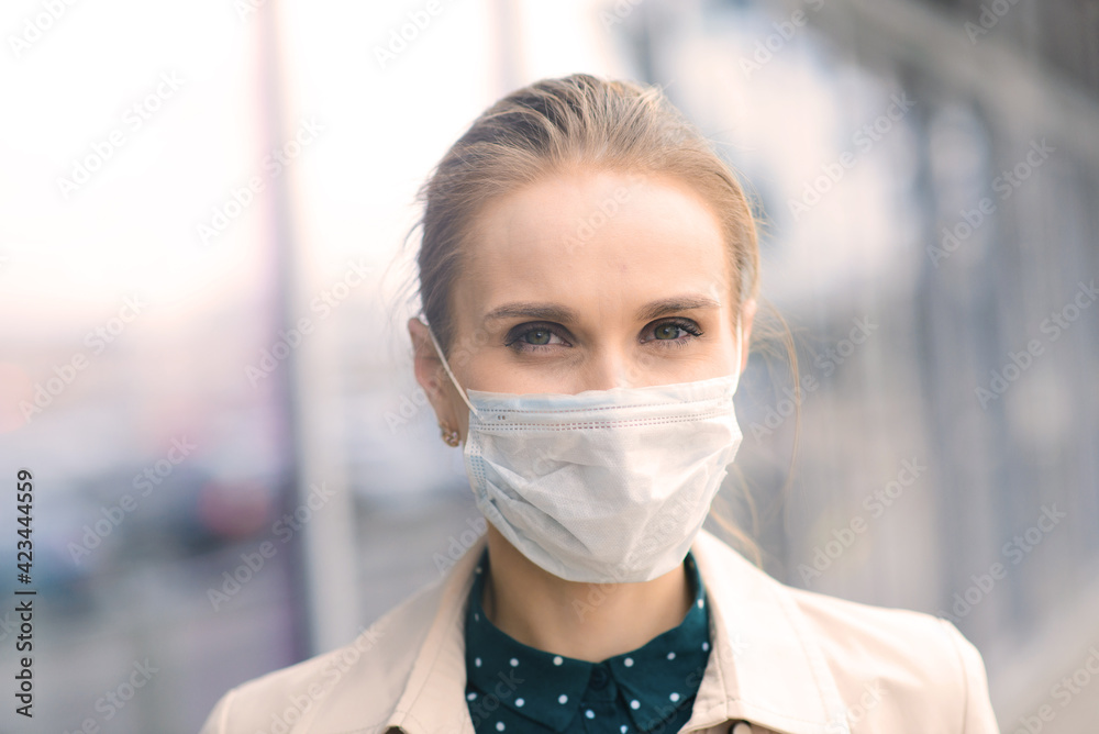 Confident woman wearing face mask and talking with somebody on mobile during coronavirus pandemic. Confident woman wearing face mask and talking with somebody on mobile during coronavirus pandemic.
