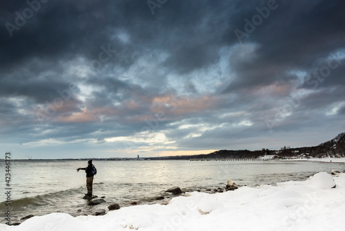 Beautiful winter see landscape with angler, panorama, Baltic See