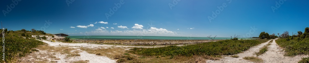 Panorama of beach and turquoise water with blue skies Panorama of beach and turquoise water with blue skies