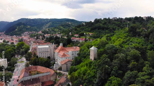 European catholic church and village old houses with red and orange colored roof. Beautiful historic landmark shot with drone aerial footage 4K 30fps.