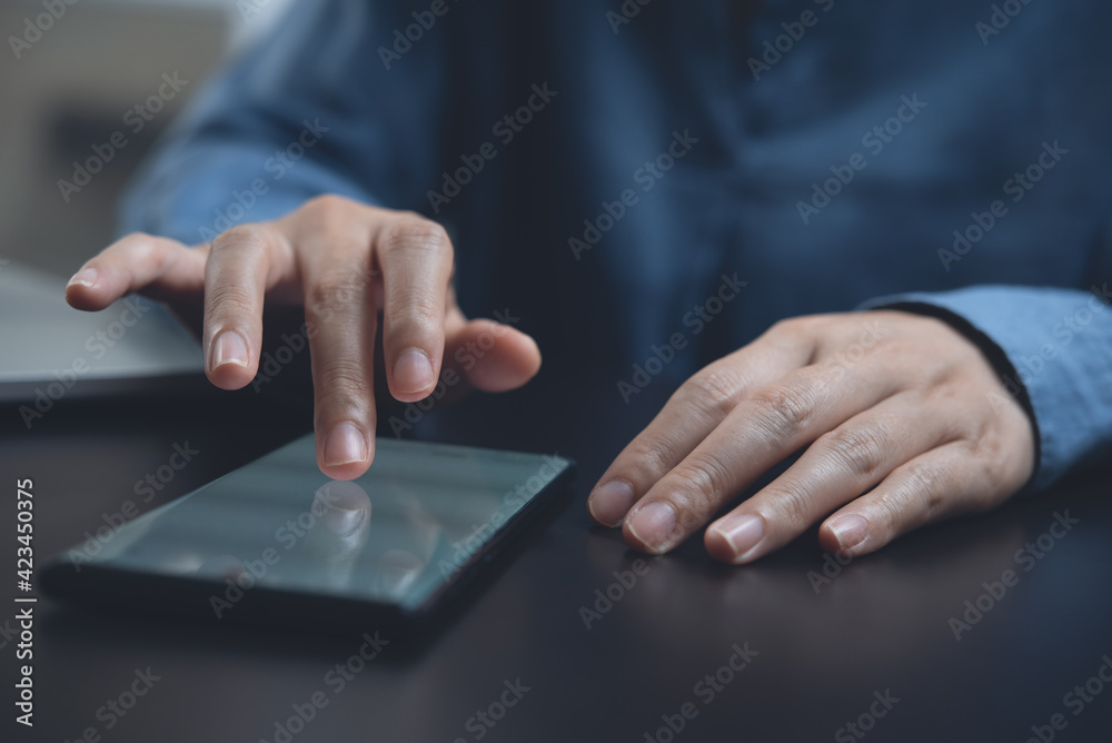 Woman using mobile smartphone and finger touching on phone screen on table, close up Woman using mobile smartphone and finger touching on phone screen on table, close up