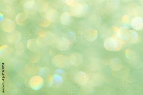 bright glitter background: bokeh effect from many colored lights on frozen glass, toning © BUSLIQ