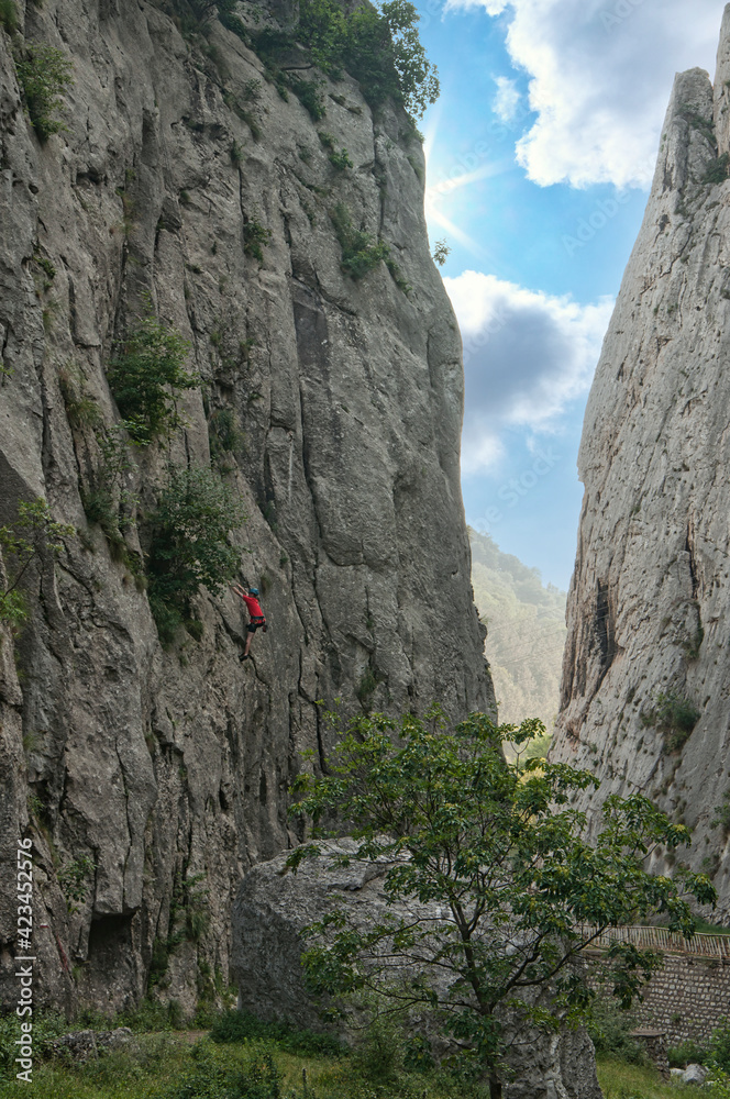 An alpinist climbing a rock in Bulgaria An alpinist climbing a rock in Bulgaria