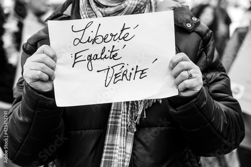 Mulhouse - France - 27 March 2021 -  people  protesting against the sanitary dictatorship  with banner liberte, egalite, verite in french, traduction in english : liberty, equality, truth photo