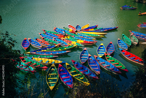 Phewa Lake with multicoloured boats in the valley of Pokhara in central Nepal. photo