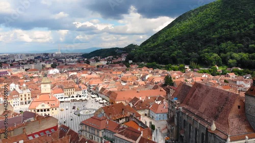 European catholic church and village old houses with red and orange colored roof. Beautiful historic landmark shot with drone aerial footage 4K 30fps.