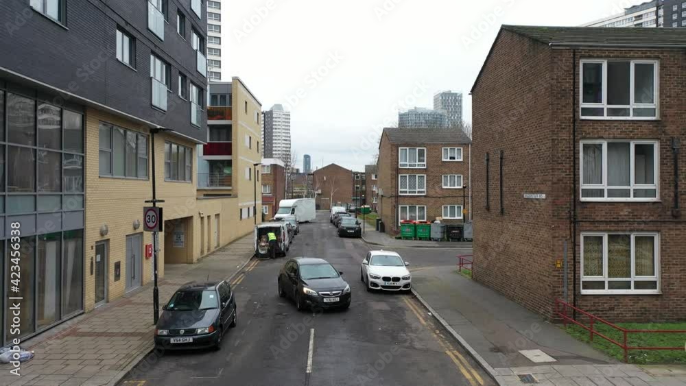 LOW ANGLE FLY OVER A VAN LEAVING GARRAGE IN RESIDENCIAL HOME