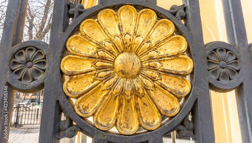 Round gold symbol as a part of iron entrance gate photo