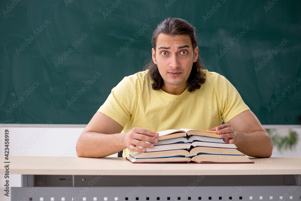 Young male student preparing for exams in the classroom Young male student preparing for exams in the classroom