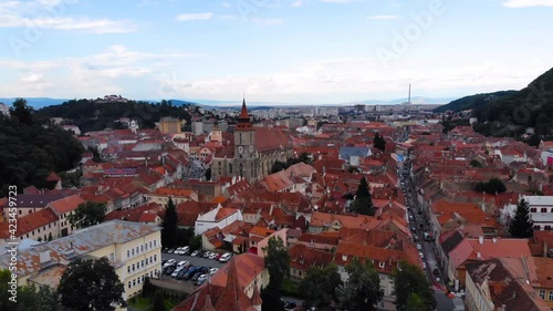 European catholic church and village old houses with red and orange colored roof. Beautiful historic landmark shot with drone aerial footage 4K 30fps.