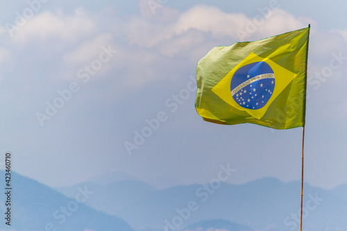 faded brazil flag outdoors on a rio de janeiro beach.
