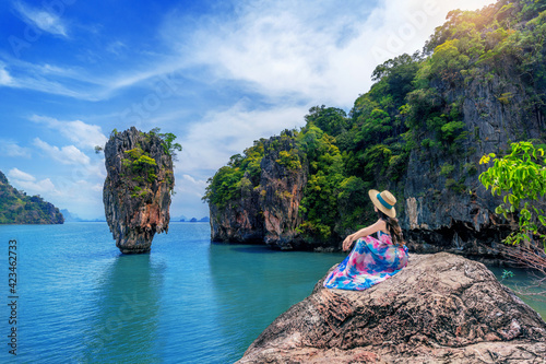 Beautiful girl sitting on the rock at James Bond island in Phang nga, Thailand. photo