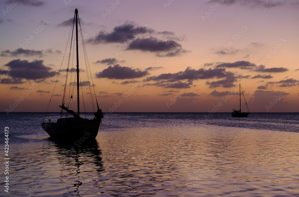 Belize Caye Caulker Island - Sailing boat anchoring at sunset