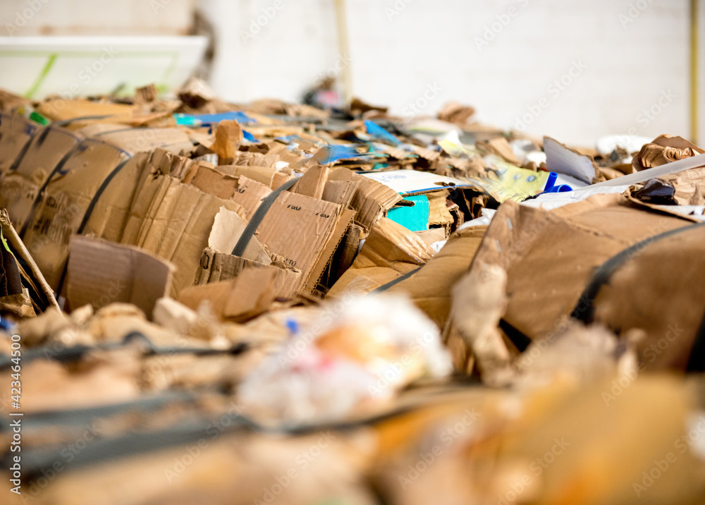 Recycle cardboard packaging concept with stacks of compressed corrugated paper garbage as a symbol to recycle for conservation and environmental technology business. Recycle cardboard packaging concept with stacks of compressed corrugated paper garbage as a symbol to recycle for conservation and environmental technology business.