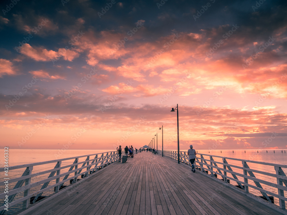 Sunrise Over Pier with People
