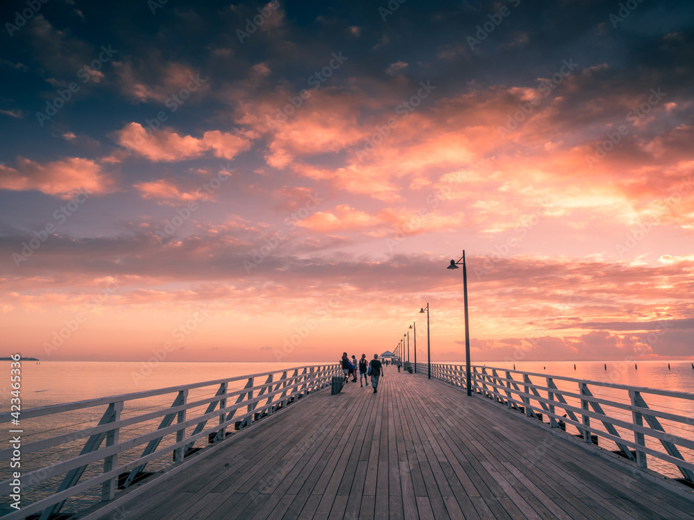 Sunrise Over Pier with People