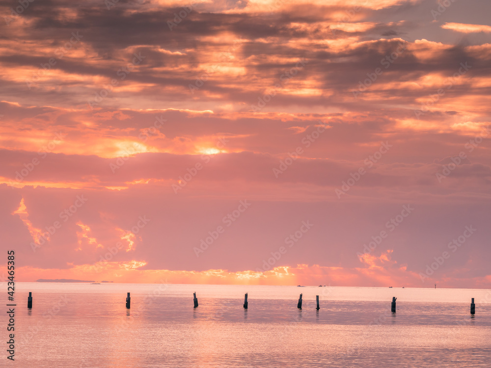 Fototapeta premium Sunrise Over The Sea with Old Pylons