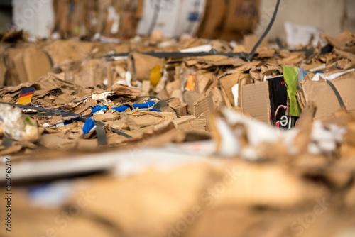 Recycle cardboard packaging concept with stacks of compressed corrugated paper garbage as a symbol to recycle for conservation and environmental technology business.