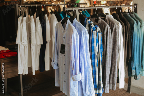 Various of shirt hanging on hanger clothes inside the store