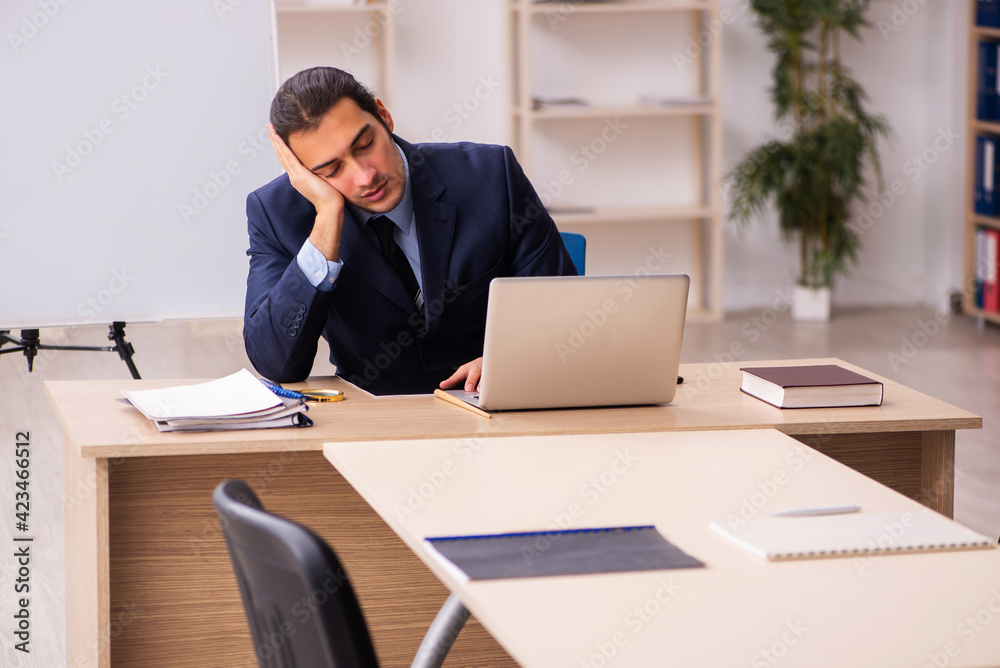 Young male employer in front of white board Young male employer in front of white board