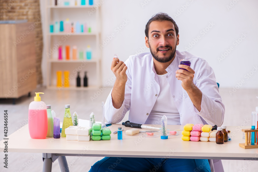 Young male chemist testing soap in the lab Young male chemist testing soap in the lab