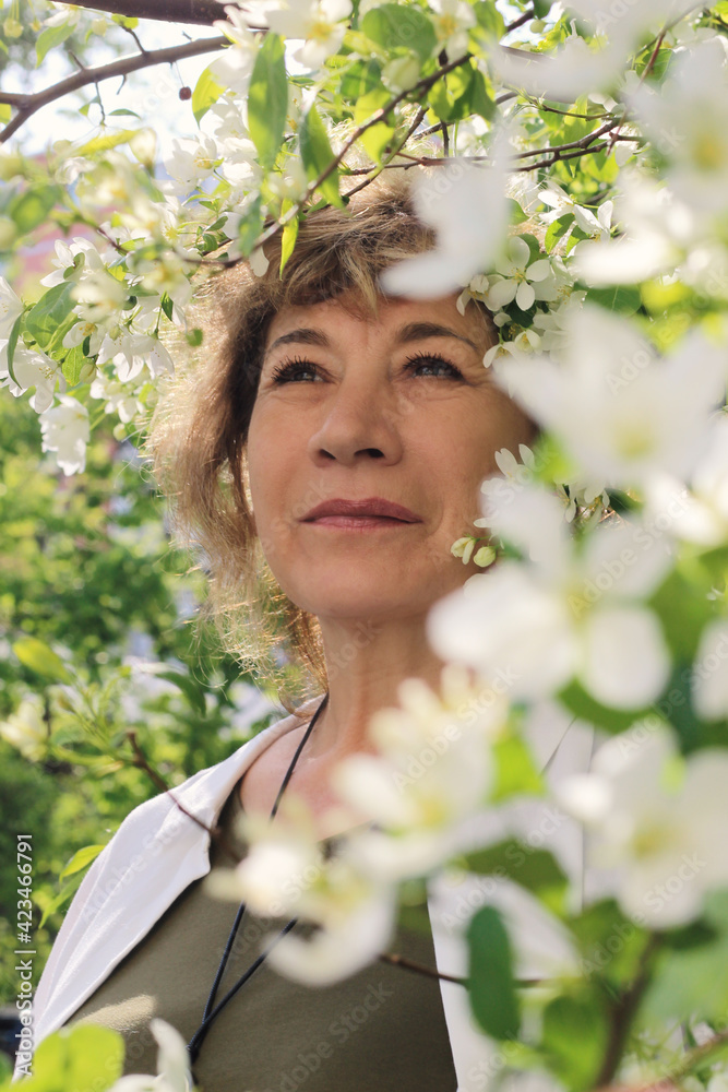 Woman walking in the park in spring. Photoshoot in bloom.