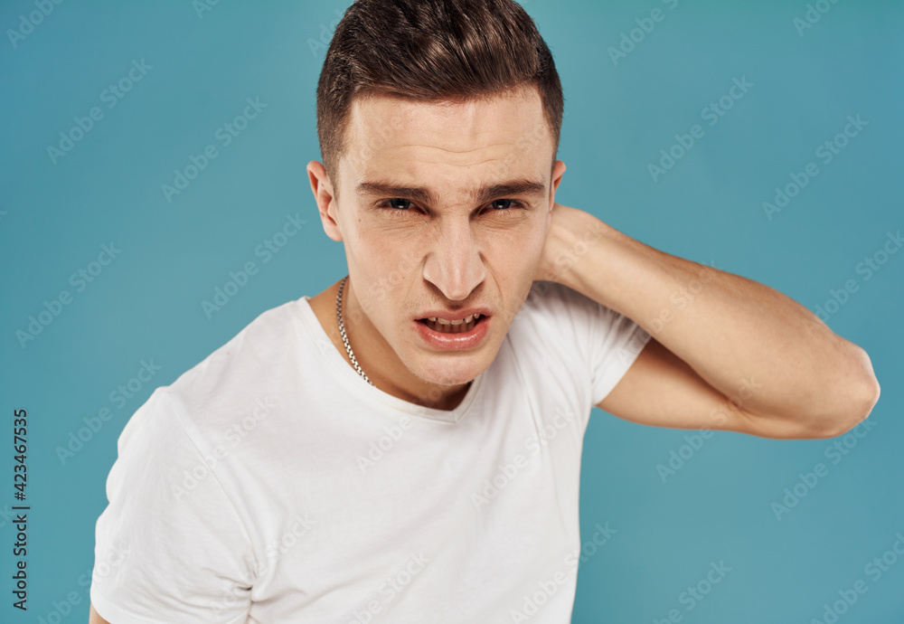 Man in t-shirt emotions gestures with hands displeasure blue background Man in t-shirt emotions gestures with hands displeasure blue background