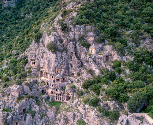 High angle drone aerial view of ancient greek rock cut lykian empire amphitheatre and tombs in Myra (Demre, Turkey) photo