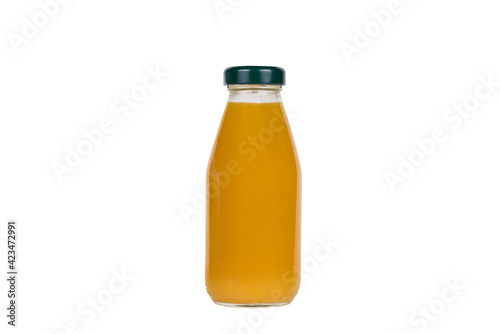 Glass bottle with peach juice on white background