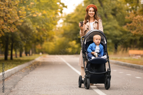 Woman and her cute baby in stroller outdoors © Pixel-Shot