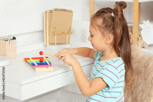 Obraz na plátně Cute little girl with xylophone at home