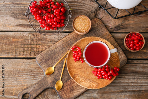 Cup of healthy viburnum tea on table