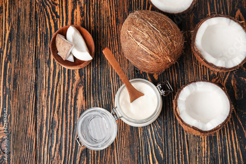 Jar of tasty coconut yogurt on wooden background