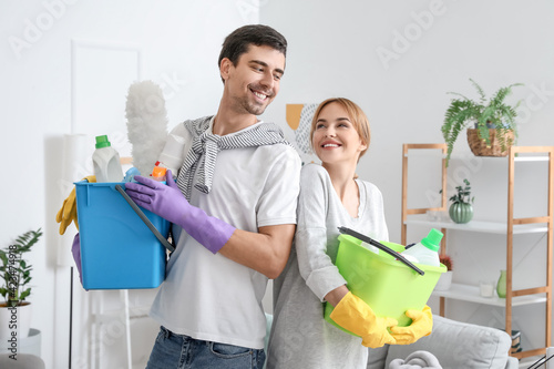 Young couple with cleaning ...