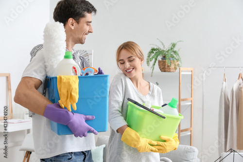 Young couple with cleaning ...