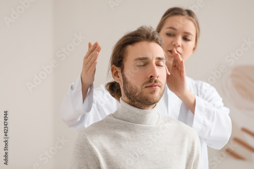 Reiki master working with p...